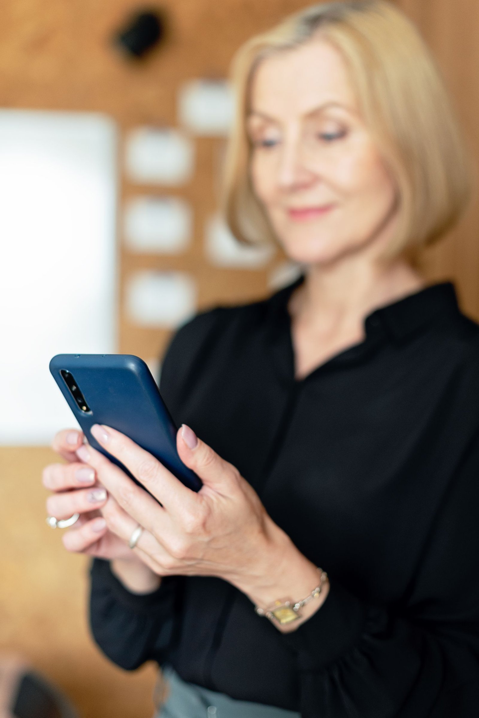 Homeowner using smartphone to get intouch with painter and decorators